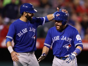 Jose Bautista #19 congratulates Russell Martin #55 of the Toronto Blue Jays after a three-run home run during the sixth inning of a game against the Los Angeles Angels of Anaheim at Angel Stadium of Anaheim on September 15, 2016 in Anaheim, California. (Photo by Sean M. Haffey/Getty Images
