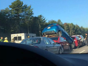 A vehicle is wedged almost upright after a vehcile behind it wedged underneath in a multi-veicle crash on Highway 417 near Boundary road Friday. There were no injuries immediately reported.