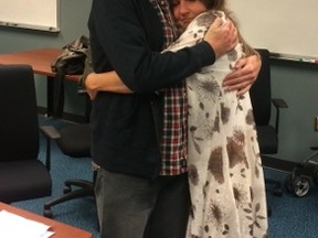 Kevin Garratt embraces his wife Julia at the Vancouver International Airport on Thursday, Sept. 15, 2016. Kevin Garratt was jailed in China for more than two years and accused of spying but has now been released and is back in Canada. (THE CANADIAN PRESS/Handout - James Zimmerman)