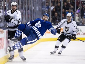 Toronto Maple Leafs defenceman Stephane Robidas, centre, gets taken out by Los Angeles Kings forward Justin Williams, left, during first period NHL hockey action in Toronto on Dec. 14, 2014. (THE CANADIAN PRESS/Nathan Denette)