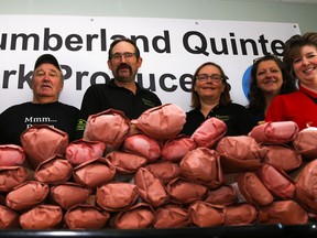 Tim Miller/The Intelligencer
A couple hundred pounds of pork line a table at The Salvation Army's kitchen on Pinnacle Street on Friday. The meat was donated by Northumberland Quinte Pork Producers for use in The Salvation Army's meal programs. Pictured left to right are: Mark Dejong, president of Northumberland Quinte Pork Producers; Major Wil Brown-Ratcliffe; Doug Farrell; Oliver and Renate Haan of Haanover View Farms; Terri Ginn; and Abby Mills, director of community and family services at the Salvation Army.