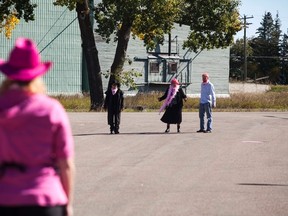 Linda Dobler, owner of The Cutting Edge, has a old-western styled standoff with Innisfree resident Ray Nedzielski, Mayor Debbie McMann, and Councillor Aaron Cannan on Thursday, September 15, 2016, in Innisfree, Alta. Dobler would later shave the heads of McMann and Cannan, as well as wax Nedzielski's chest for breast cancer awareness. Taylor Hermiston/Vermilion Standard/Postmedia Network.