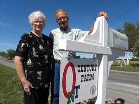 Ernst Kuglin/The Intelligencer
Ron and Janet Hamilton stand by the Century Farm sign at their Hamilton Road family farm. The Quinte West couple, along with five other nominees, will be inducted to the Wall of Fame at Farmtown Park in Stirling Sunday afternoon at 2 p.m.