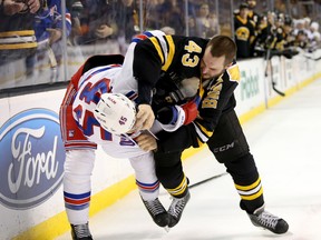 New York Rangers left winger James Sheppard fights with Boston Bruins defenceman Matt Bartkowski on March 28, 2015 in Boston. (AP Photo/Mary Schwalm)