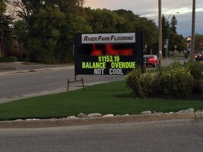 River Park Flooring put up an attention-grabbing sign on Monday that said the customer had an outstanding balance of more than $1,100.