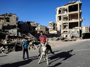 Sameer Al-Doumy/Getty Images
A Syrian boy rides a donkey as they play in the rebel-held town of Douma, on the eastern edges of the capital Damascus, on the second day of Eid al-Adha Muslim holiday on Sept. 13.