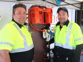 Andy Cassibo, left, and his brother Gregory Cassibo, in Kingston. on Friday, stand at the first aid tent they set up each day at the Kingston Fall Fair. The most common ailment thay have to deal with are bee stings.(Michael Lea/The Whig-Standard)