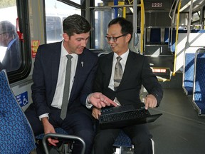 Don Iveson (left/Mayor of Edmonton) and Dr. Zhi-Jun (Tony) Qiu (right/Assistant Professor, Transportation Engineering, University of Alberta) discuss the ACTIVE-AURORA project, a wireless connected vehicle project now being tested on Edmonton roads, while on a city bus tour in Edmonton on September 16, 2016. Photo by Larry Wong/Postmedia