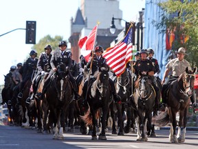 Participants of the North American Police Equestrian Championships parade down Princess Street in Kingston, Ont. on Friday September 16, 2016. Steph Crosier/Kingston Whig-Standard/Postmedia Network