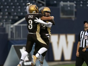 University of Manitoba Bisons SB Riley Harrison (right) celebrates his touchdown catch against the University of Alberta Golden Bears. (KEVIN KING/Winnipeg Sun)