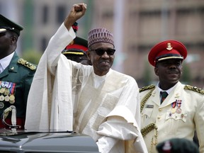 FILE - In this May 29, 2015 file photo, Nigeria President Muhammadu Buhari salutes his supporters during his inauguration in Abuja, Nigeria. Nigeria's President Muhammadu Buhari has apologized for plagiarizing President Barack Obama's 2008 victory speech and says he will punish those responsible. Adeola Akinremi in her Friday, Sept. 16, 2016 column for ThisDay newspaper denounced "the moral problem of plagiarism on a day Mr. President launched a campaign to demand honesty and integrity." (AP Photo/Sunday Alamba, File)