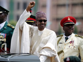 In this May 29, 2015 file photo, Nigeria President Muhammadu Buhari salutes his supporters during his inauguration in Abuja, Nigeria. Nigeria's President Muhammadu Buhari has apologized for plagiarizing President Barack Obama's 2008 victory speech and says he will punish those responsible. Adeola Akinremi in her Friday, Sept. 16, 2016 column for ThisDay newspaper denounced "the moral problem of plagiarism on a day Mr. President launched a campaign to demand honesty and integrity."