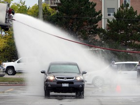 Kingston Fire and Rescue hosted a carwash at the Kingston Centre with proceeds going to the Fill the Boot campaign in Kingston, Ont. on Saturday September 17, 2016. The campaign supports  Muscular Dystrophy Canada. Steph Crosier/Kingston Whig-Standard/Postmedia Network