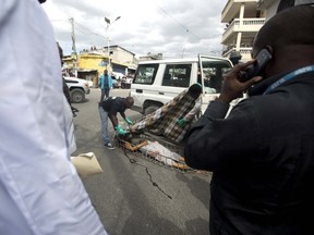 Morgue workers cover the body of slain Spanish nun Isabelle Sola Matas after she was attacked in her car in downtown Port-au-Prince, Haiti, Friday, Sept. 2, 2016. Local judge Noel Jean Brunet said that two men on a motorcycle drove by and killed the 51-year-old Roman Catholic nun while she was driving. Matas worked at St. Joseph church where she directed a program providing people with prosthetic limbs. (AP Photo/Dieu Nalio Chery)