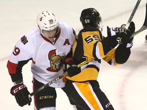 Senators' Andreas Englund (left) ties up Penguins' Jake Guentzel during their afternoon game of the 2016 Rookie tournament at Budweiser Gardens in London, Ont. on Saturday, Sept. 17, 2016. (Mike Hensen/Postmedia Network)