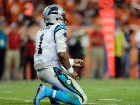 Panthers quarterback Cam Newton takes a knee after being hit against the Broncos during second half NFL action in Denver on Sept. 8, 2016. (Joe Mahoney/AP Photo)