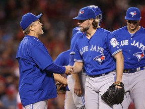Starting pitcher R.A. Dickey #43 of the Toronto Blue Jays hands the ball to manager John Gibbons as he is relieved in the sixth inning against the Los Angeles Angels of Anaheim at Angel Stadium of Anaheim on September 16, 2016 in Anaheim, California. (Photo by Stephen Dunn/Getty Images)