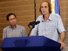 Released Norwegian hostage Kjartan Sekkingstad, right, briefly delivers his statement after meeting Philippine President Rodrigo Duterte in Davao city in southern Philippines Sunday, Sept. 18, 2016. (AP Photo/Manman Dejeto)