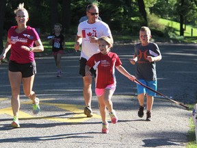 Veronica Ceponis, left, Greg Armstrong, his kids Ð Andie, 9, and Graham, 12 Ð and their dog Phoenix, run in Canatara Park Sunday. They were among hundreds taking part in the 37th annual Terry Fox Run in Sarnia. (Tyler Kula/Sarnia Observer/Postmedia Network)
