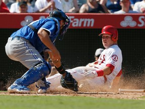 Angels baserunner Mike Trout (right) is safe at home as Blue Jays catcher Dioner Navarro attempts to tag him during fifth inning MLB action in Anaheim, Calif., on Sunday, Sept. 18, 2016. (Christine Cotter/AP Photo)