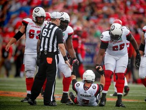 Redblacks quarterback Trevor Harris is helped up by J'Michael Deane and SirVincent Rogers during a game against the Stampeders in Calgary on Saturday, Sept. 17, 2016. (Al Charest/Postmedia Network)