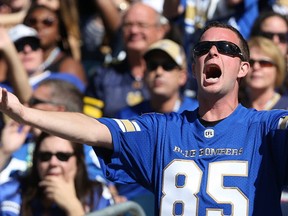 A Winnipeg Blue Bombers fan calls the defence to action against the Toronto Argonauts during CFL action in Winnipeg on Sat., Sept. 17, 2016. A recent survey found most fans are predicting the Bombers will win the Grey Cup this year. (Kevin King/Winnipeg Sun/Postmedia Network)