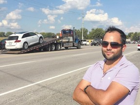 Mohamed Khanafer remains at the scene of a crash Sunday, after he pulled a woman from the wreckage of a white car which was T-boned on Dundas Street near the airport. (MIKE HENSEN, The London Free Press)