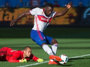 Toronto FC's Jozy Altidore (right) dribbles past New York Red Bulls keeper Luis Robles during MLS action in Toronto on Sunday, Sept. 18, 2016. (Chris Young/The Canadian Press)