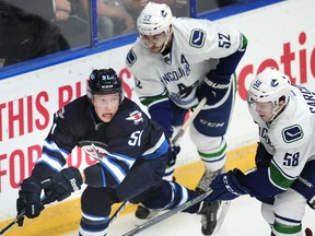 PENTICTON, BC., September 18, 2016 -- Vancouver Canucks' Cole Cassels (52) and Michael carcone (58) pursue Winnipeg Jets' Luke Green (51) during third period 2016 NHL Young Stars Classic action at the South Okanagan Events Centre in Penticton, BC., September 18, 2016. (NICK PROCAYLO/PostMedia) 00045181A ORG XMIT: 00045181A