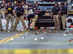 Members of the Federal Bureau of Investigation (FBI) carry on investigations at the scene of Saturday's explosion on West 23rd Street and Sixth Avenue in Manhattan's Chelsea neighbourhood, New York, Sunday, Sept. 18, 2016. An explosion rocked the block of West 23rd Street between Sixth and Seventh Avenues at 8:30 p.m. Saturday. (AP Photo/Andres Kudacki)