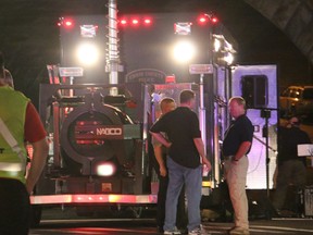 Bomb squad personnel stand around the scene of an explosion near the train station early Monday, Sept. 19, 2016, in Elizabeth, N.J. A suspicious device found Sunday night in a trash can near a New Jersey train station exploded early Monday as a bomb squad robot attempted to disarm it. (Jessica Remo/NJ Advance Media for NJ.com via AP)