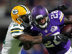 Minnesota Vikings running back Adrian Peterson (28) tries to break a tackle by Green Bay Packers free safety Ha Ha Clinton-Dix, left, Sunday, Sept. 18, 2016, in Minneapolis. (AP Photo/Andy Clayton-King)