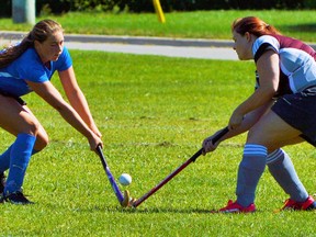 Emily Ruby (left) of the MDHS field hockey team battles for the ball against Northwestern Sept. 14. SUBMITTED