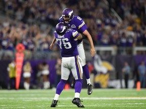 Alex Boone of the Minnesota Vikings celebrates with quarterback Sam Bradford after a touchdown pass in the third quarter of the game on against the Green Bay Packers Sept. 18, 2016 at US Bank Stadium. (Hannah Foslien/Getty Images)