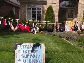 Rae Mahoney-Robbs plastered her front yard with brassieres for a birthday joke for her husband last week.(Shaun Gregory/Huron Expositor)