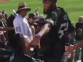 Raiders fans fight during the Oakland-Atlanta NFL game (Twitter video screen grab)