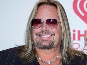 In this Sept. 19, 2014, file photo, Vince Neil of Motley Crue, arrives at the iHeart Radio Music Festival in Las Vegas. Attorneys for the rocker have said they are investigating what led to a misdemeanor battery charge accusing Neil of grabbing a woman's hair and pulling her to the ground in April outside a Las Vegas Strip resort. (Photo by Andrew Estey/Invision/AP, File)
