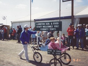 Bryan Boyle, agricultural representative for Lambton County and IPM '91 executive committee member, pushes his children Jessica, Brittany and Matthew in the opening day IPM '91  parade. The 1991 International Plowing Match was held on farms in Enniskillen Township, just outside of Petrolia. (Handout/Sarnia Observer/Postmedia Network)