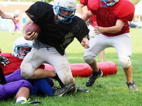 Great Lakes junior boys' football player Tyler Steeves, right, tries to tackle ball carrier Corbin Mackenzie during practice at the school on Thursday September 15, 2016 in Sarnia, Ont. Recently consolidated Great Lakes Secondary School does not have an official sports name or colours yet, but suggestions are being accepted online at glss.lkdsb.net until Oct. 7. (Terry Bridge/Sarnia Observer/Postmedia Network)