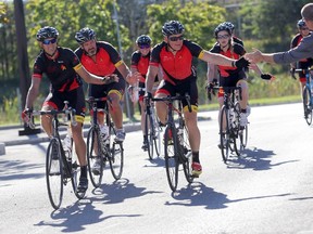 Emily Mountney-Lessard/The Intelligencer 
Riders in the Sears National Kids Cancer Ride are greeted as they arrive at the Sears distribution centre on College Street East on Monday in Belleville.