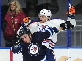 Winnipeg Jets' Brendan Lemieux (48) against the boards with Edmonton Oilers' Kayle Doetzel (89) during first period 2016 NHL Young Stars Classic action at the South Okanagan Events Centre in Penticton, BC., September 19, 2016.