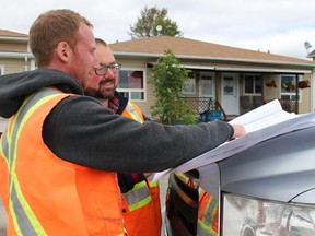 Shane Skinner, Director of Operations ad Infrastructure, looks over the plans for the resurfacing of Fifth Street with Andrew Dorland, of EXP , is expected to be complete by the end of construction season sometime in November depending on the weather.