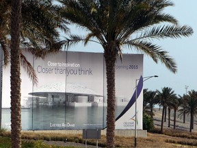 In this Tuesday, April 16, 2013 file photo, a giant billboard announces the 2015 opening of the Abu Dhabi branch of the Louvre construction site in Abu Dhabi, United Arab Emirates. A much-anticipated Mideast outpost of the Louvre now has its first director. But visitors will have to wait until next year to visit the new art museum.
The Abu Dhabi Tourism and Culture Authority said Tuesday the Louvre branch in the United Arab Emirates capital will host its first visitors in 2017. (AP Photo/Kamran Jebreili, File)
