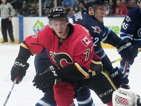 Calgary Flames' Mark Jankowski (77) has in the puck in front of Winnipeg Jets' Jack Roslovic (52) during second period 2016 NHL Young Stars Classic action at the South Okanagan Events Centre in Penticton, BC., September 16, 2016.