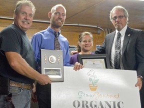 Coun. Steve Pinsonneault of Ward 3, Rob Brown of the CK Chamber of Commerce, and Mayor Randy Hope present Sandra Carther with Industry of the Month for Carther Plants. The Thamesville company grows vegetables and strawberries and has been recognized for its innovation and excellence in agriculture.