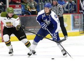 Ryan Valentini, right, of the Sudbury Wolves, attempts to skate past Brett Hargrave, of the North Bay Battalion, during OHL action at the Sudbury Community Arena in Sudbury, Ont. on Friday March 18, 2016. John Lappa/Sudbury Star/Postmedia Network