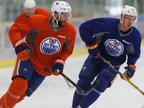 Edmonton's Eric Gryba (62) skates with Connor McDavid (97) during an Edmonton Oilers practice at Leduc Recreation Centre in Leduc, Alta., on Friday April 8, 2016.