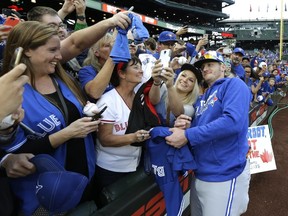 Blue Jays’ Josh Donaldson poses for a photo with a fan before Monday’s game in Seattle.