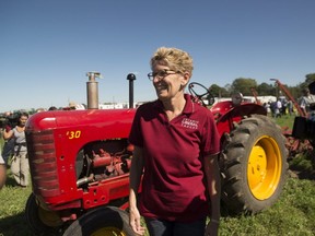 Ontario Premier Kathleen Wynne takes part in a plowing competition during the International Plowing Match in Harriston, Ont. on Tuesday, September 20, 2016. THE CANADIAN PRESS/Hannah Yoon