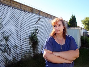 Poplynn Drive resident Julie Graveline stands in her back yard in Winnipeg, Man. Tuesday September 20, 2016. She and other residents want a bylaw put into effect to eliminate some of the noise coming from a fuel card lock behind their homes.
